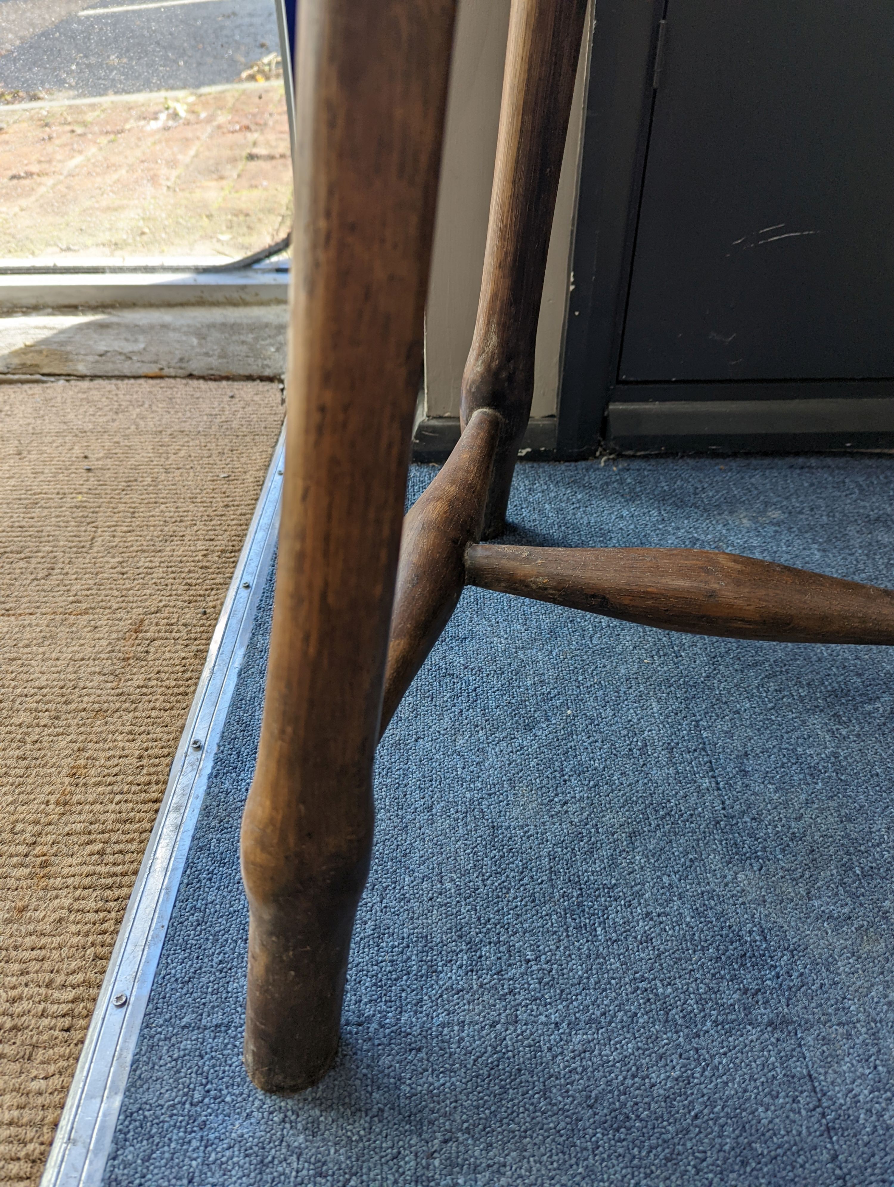 A circular burr elm and ash primitive cricket table with T shaped stretcher, diameter 44cm, height 61cm